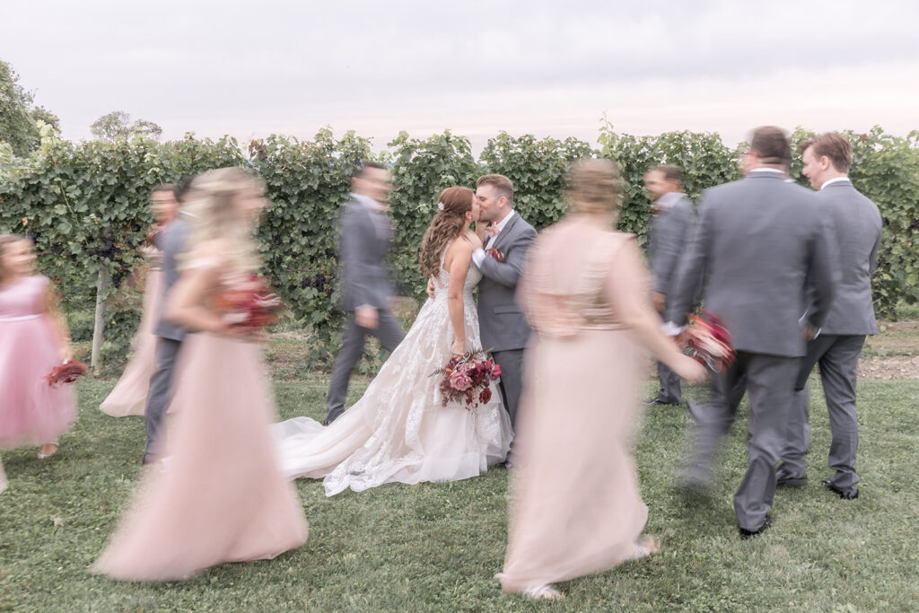 Bride and groom surrounded by wedding party